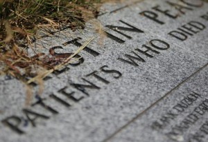 The headstone of a mass grave containing the remains of patients who died at the Western State Hospital in Lakewood, Wash. is shown. Volunteers are seeking to place named markers on the more than 3,000 graves at the hospital, which were previously only marked by numbers. 