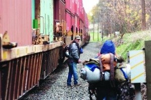Christopher Schiller looks back towards his friends Claudia Lavadour and Brian Bettencourt as a train rumbles down the tracks recenlty in Pendleton.