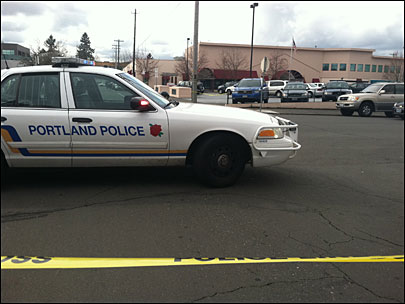 Portland Police investigate a suicide in their North Precinct parking lot Saturday.