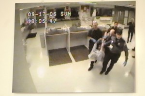 This image shows police carrying James Chasse into the jail. The image was on display during a 2010 press conference.