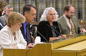 Mary Claire Buckley, then-director of the PSRB, addresses the Emergency Board as Janette Williams (L) and Bob Nikkel listen.